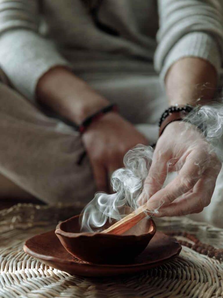 A woman smudging while sitting down.