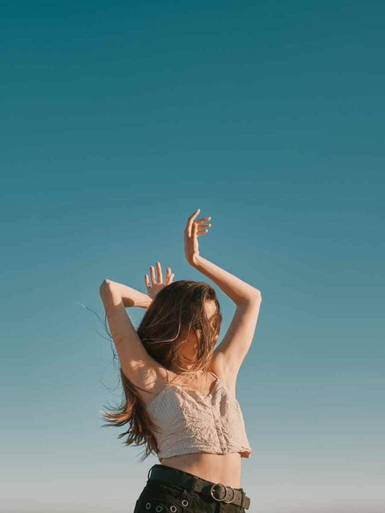 Woman dancing outdoors.