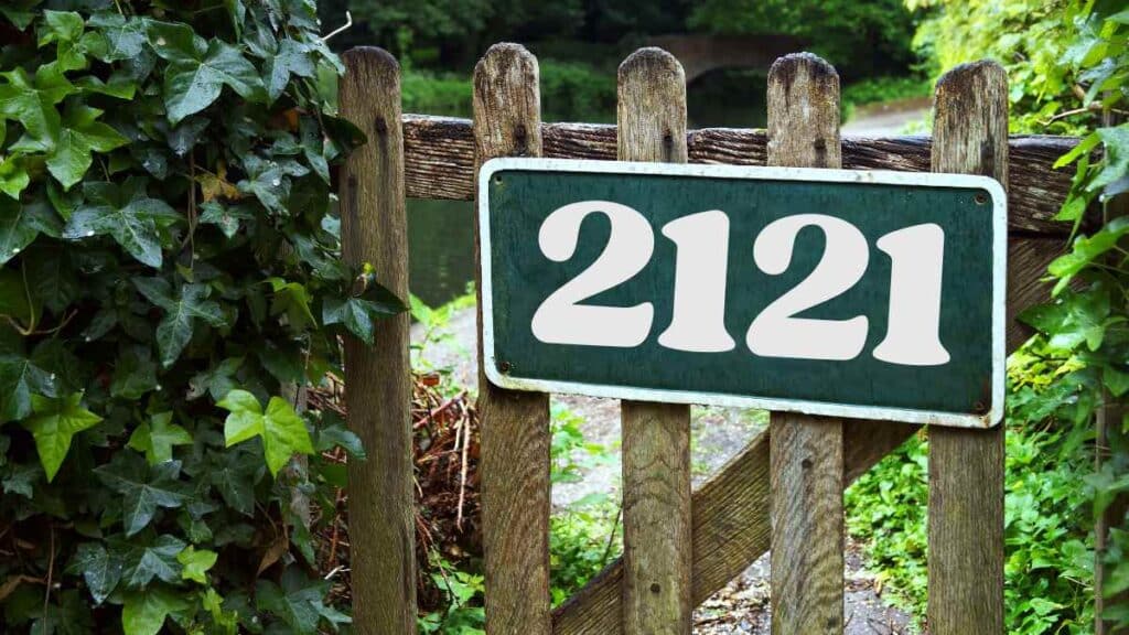Gate sign with the angel number 2121 in nature